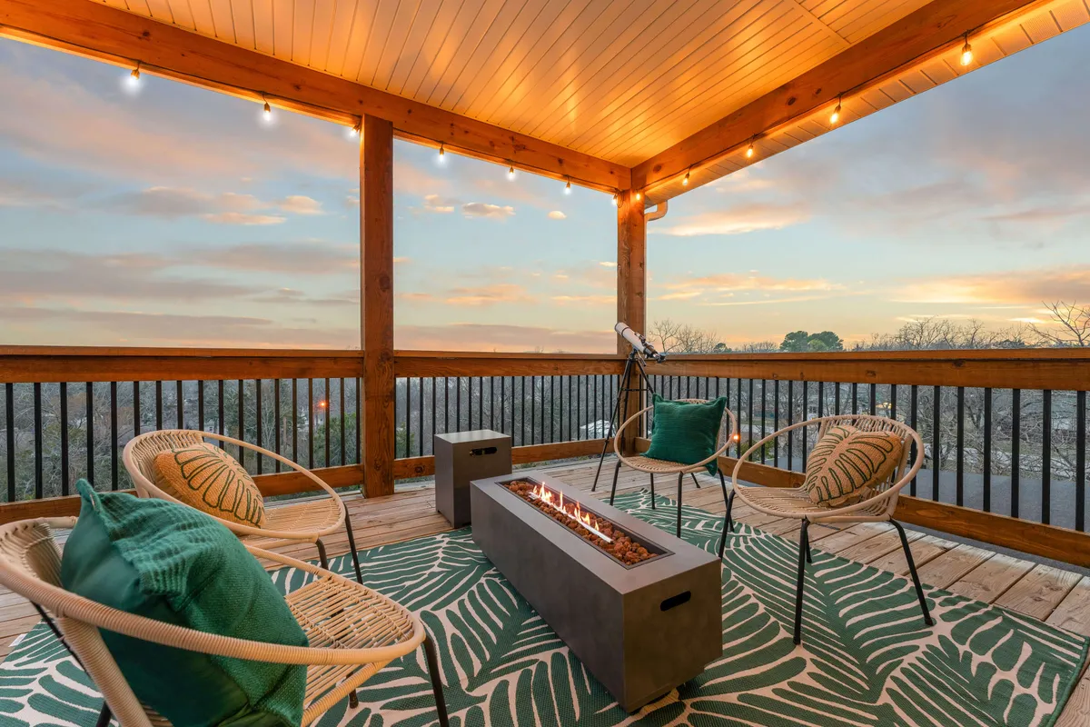 A cozy outdoor fire pit with surrounding seating, set against a horizon view and complemented by a decorative outdoor rug. The setup is perfect for group gatherings, storytelling, and unwinding together as evening falls.
