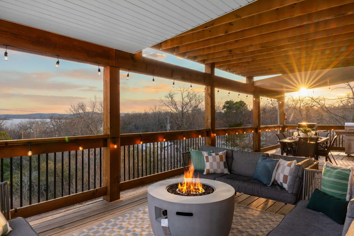 A cozy outdoor fire pit area with comfortable seating and expansive sunset views over the landscape. The mood is tranquil and inviting, perfect for evening relaxation and intimate gatherings under the stars.